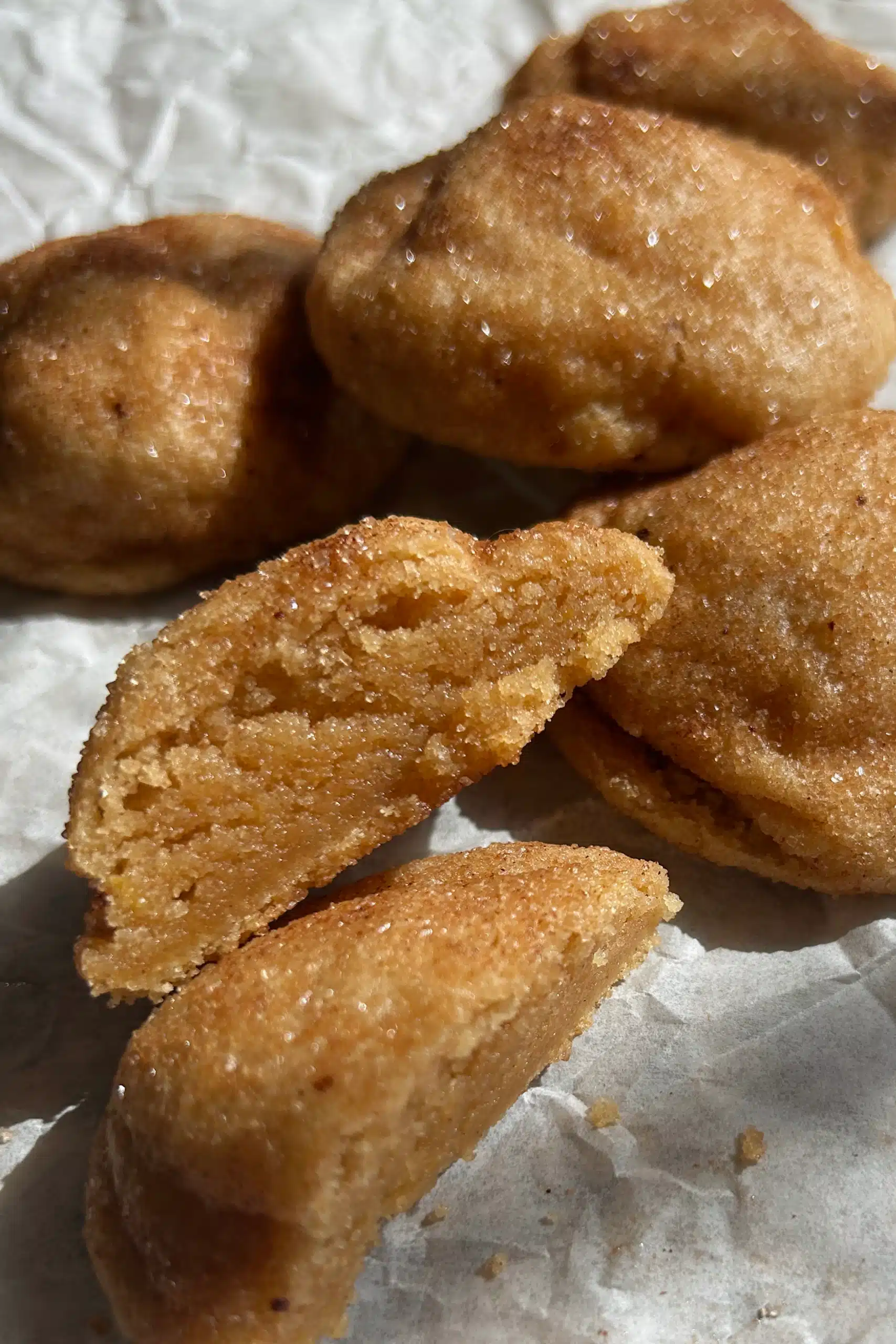 Brown Butter Snickerdoodle cut in half to show the extra soft gooey center.