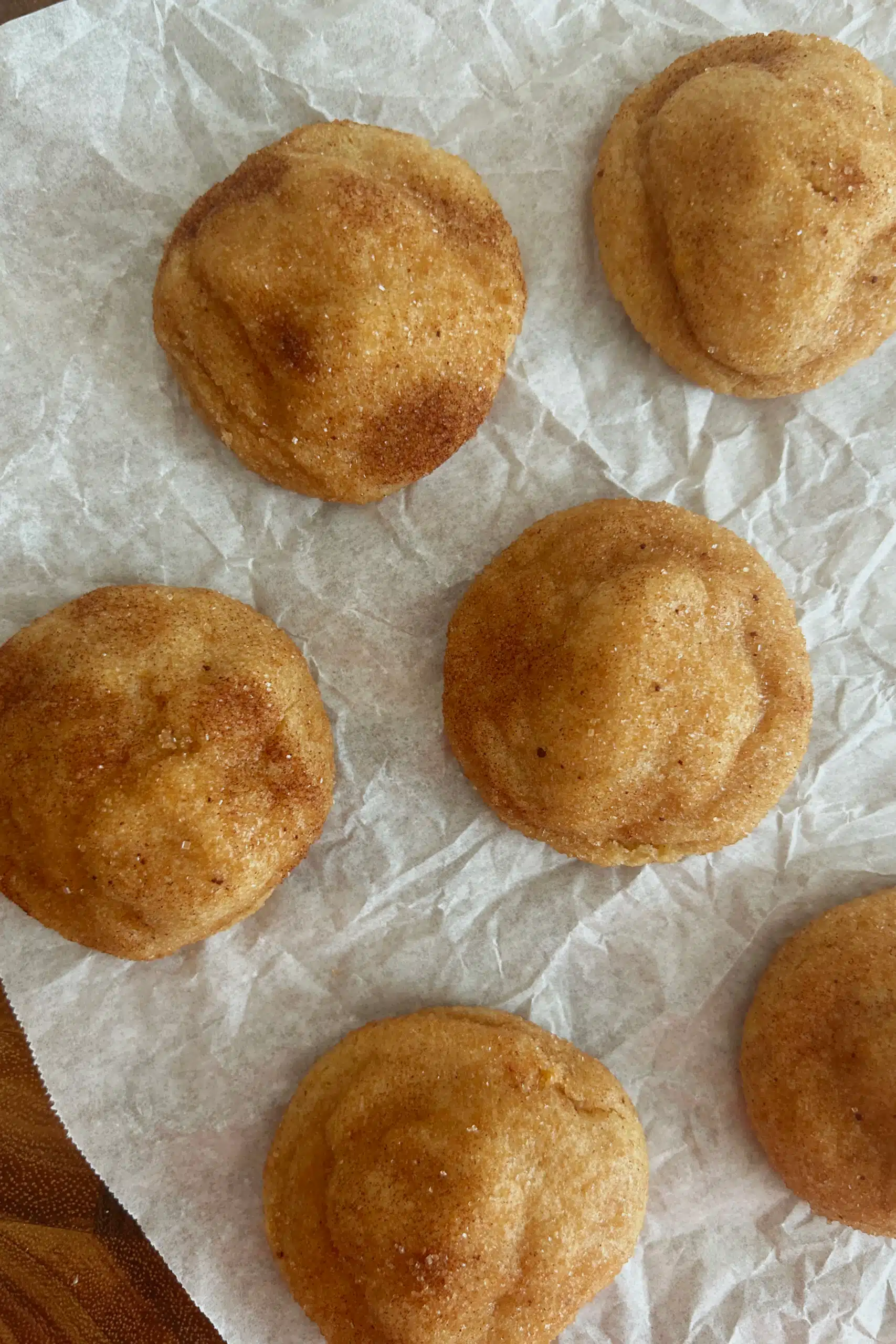 Brown butter snickerdoodles on parchment paper.